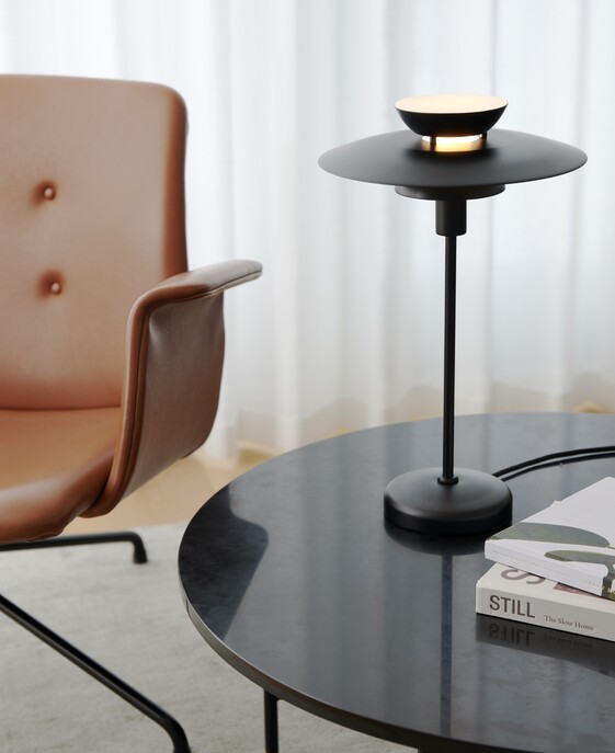 Stolní světlo Carmen od Nordluxu v minimalistickém designu s vrstveným stínítkem.