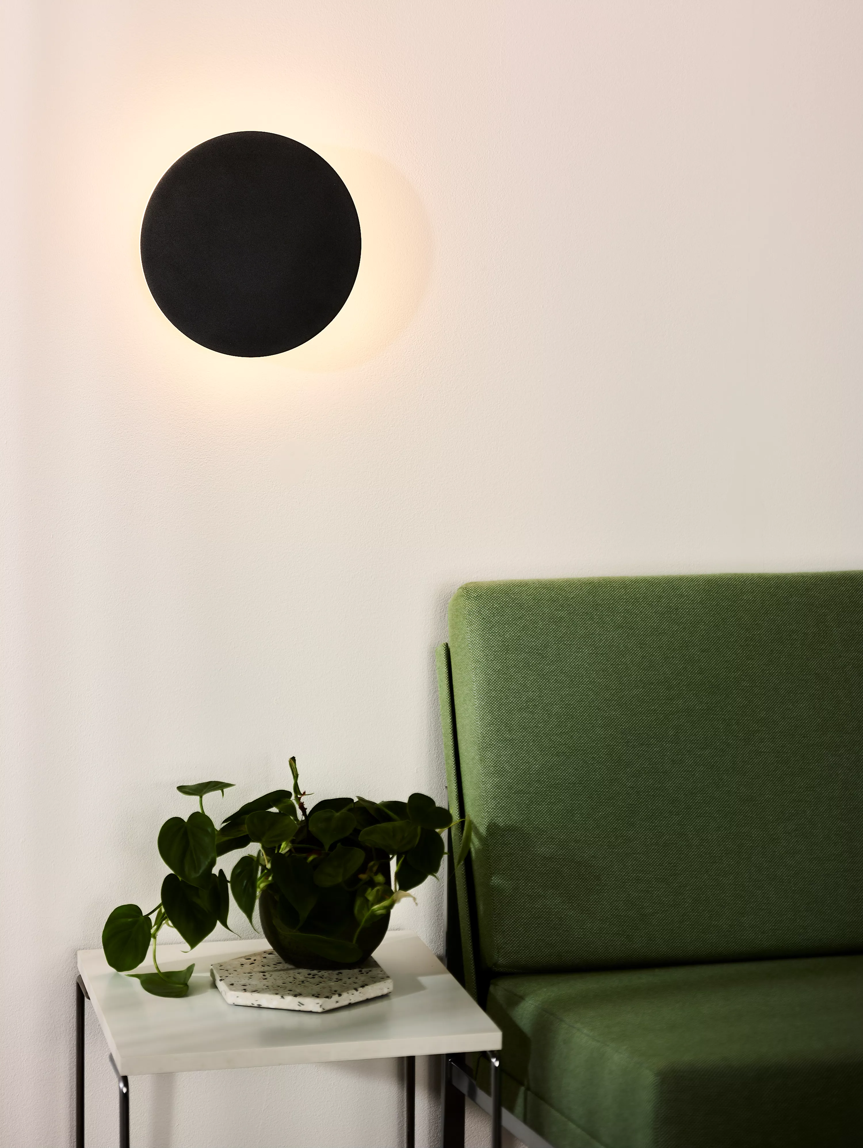 Nástěnné svítidlo Eklyps vytvoří na stěně kruhovou záři, k dostání v černém provedení.