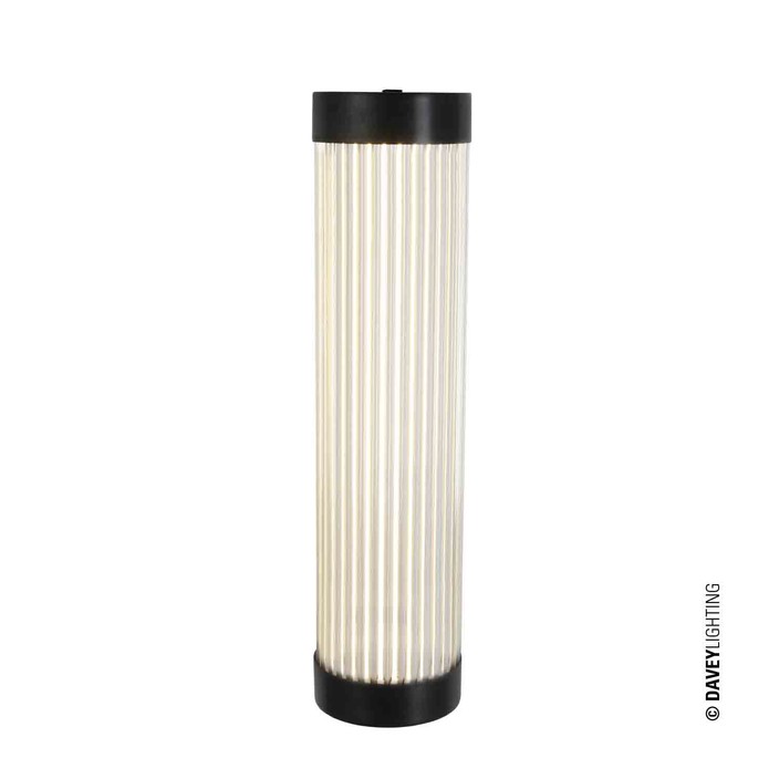 Úzká nástěnná lampička Pillar od Original BTC. Čiré skleněné trubice. Základna a vršek kov. Art Deco styl, vhodná do koupelny  (mosaz s patinou)
