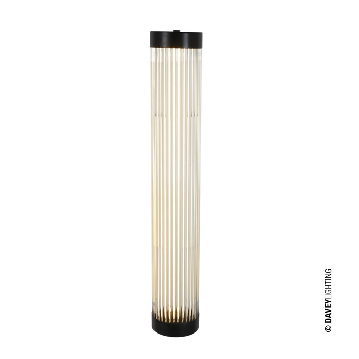 Úzká nástěnná lampička Pillar od Original BTC. Čiré skleněné trubice. Základna a vršek kov. Art Deco styl, vhodná do koupelny  (mosaz s patinou)